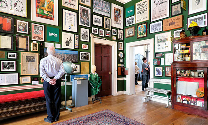 Man looking at interior wall of Little Museum of Dublin