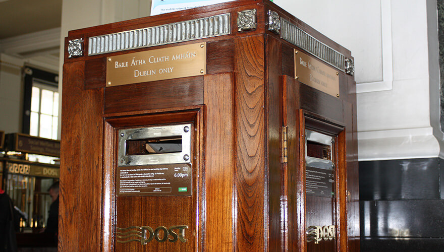 large, mahogany postbox inside the gpo