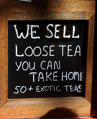 Chalkboard reads: We sell loose tea you can take home. 50+ exotic teas
